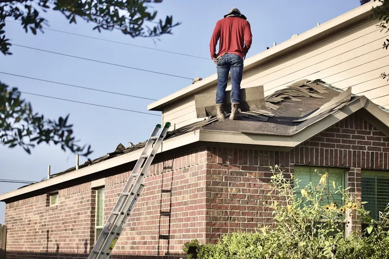Professional roofer working on a residential roof in Union Beach